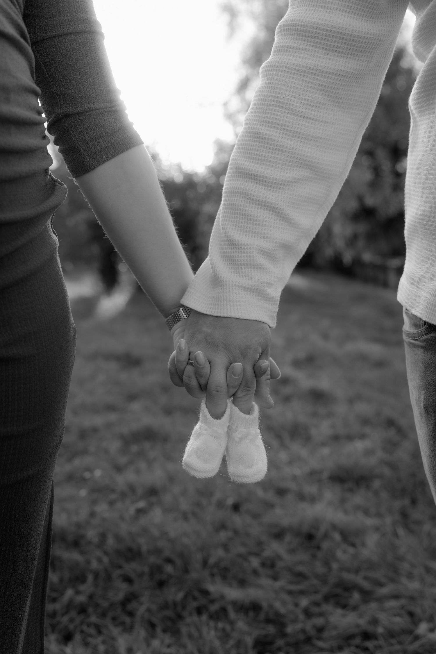 Frau und Mann halten Babyschuhe in den Händen