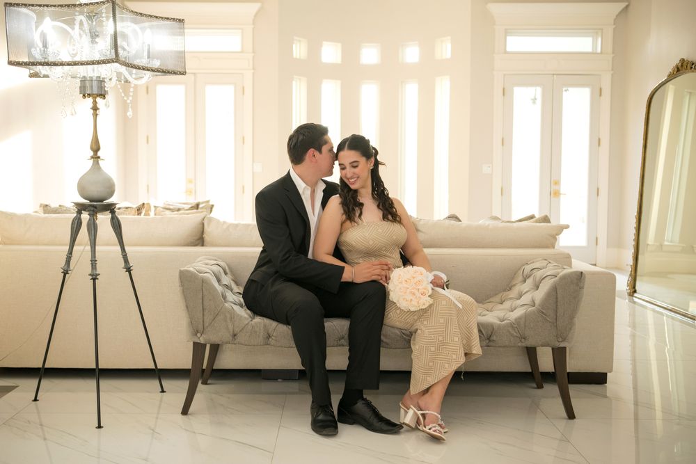 Intimate couple portrait session in bright white modern interior room with natural lighting.