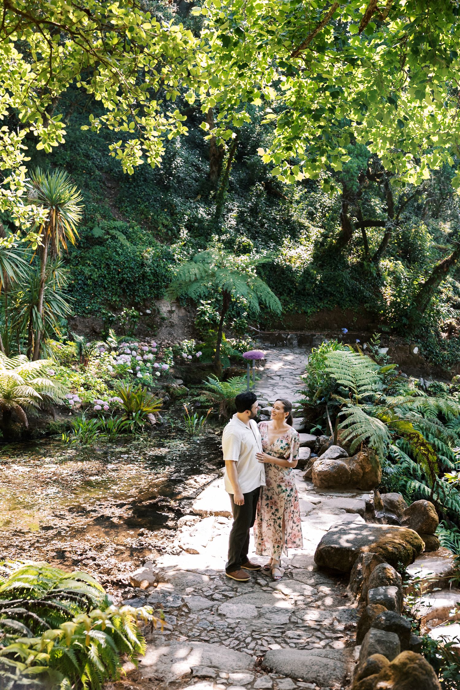 Couple walking through Mediterranean gardens in Sintra engagement session