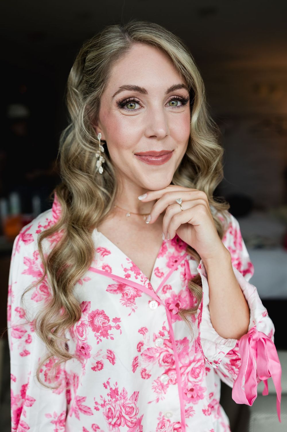 A series of photos showing someone in a pink and white floral dress making playful expressions and poses.