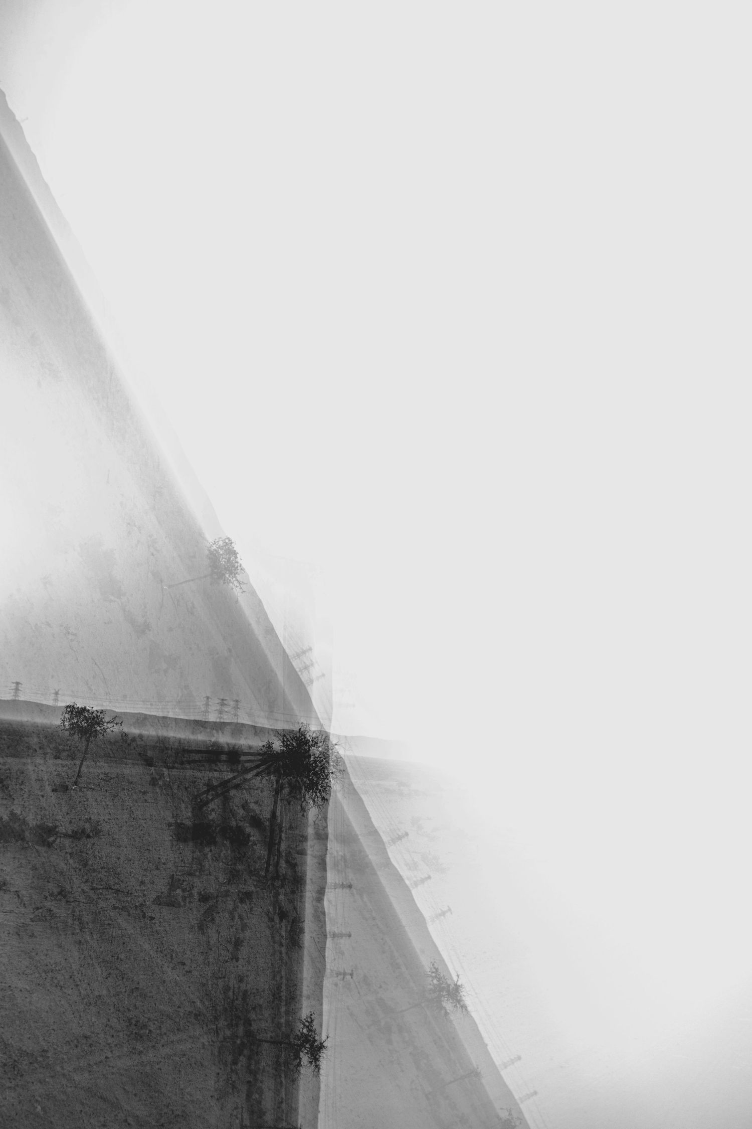 Abstract black and white architectural detail shows geometric angles and shadows in minimalist composition.
