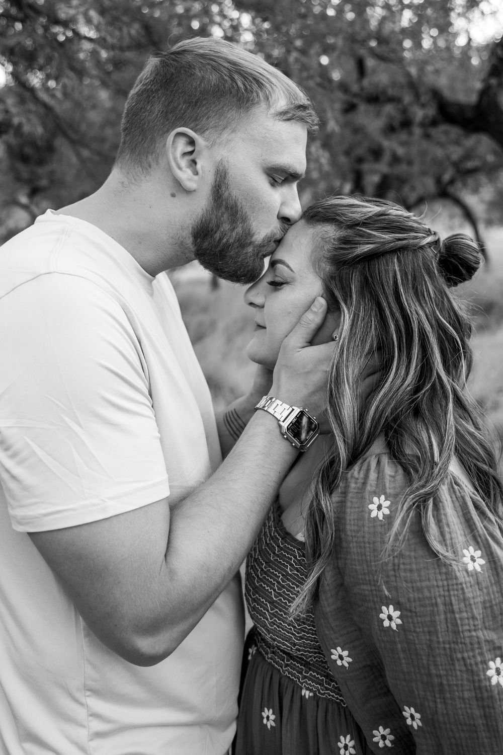A romantic series of black and white photos showing tender kisses and intimate moments between a couple.