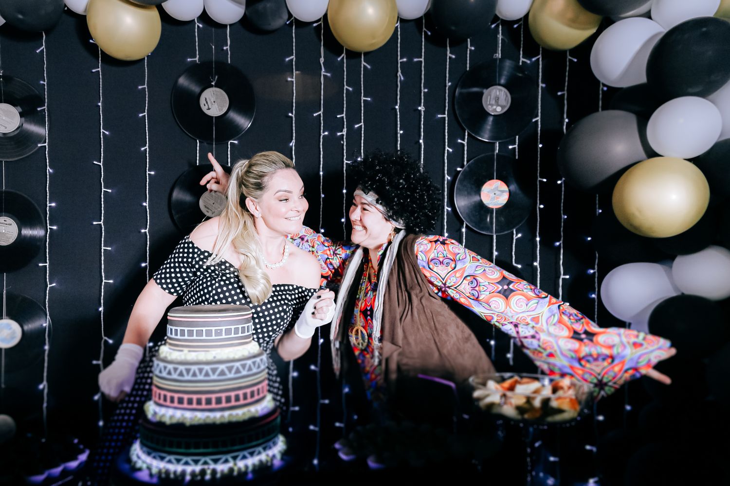Retro-themed birthday party in Wimbledon: pose playfully with vinyl décor, balloons, string lights, and a colourful cake.