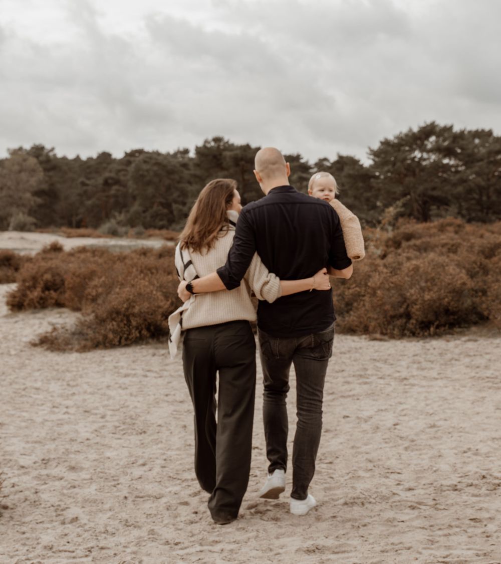 A couple walking together on a beach path, shown in a series of black and white photos from behind.