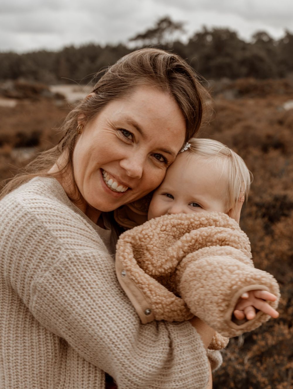 A series of warm-toned candid photos showing tender moments of affection and laughter in an outdoor natural setting.