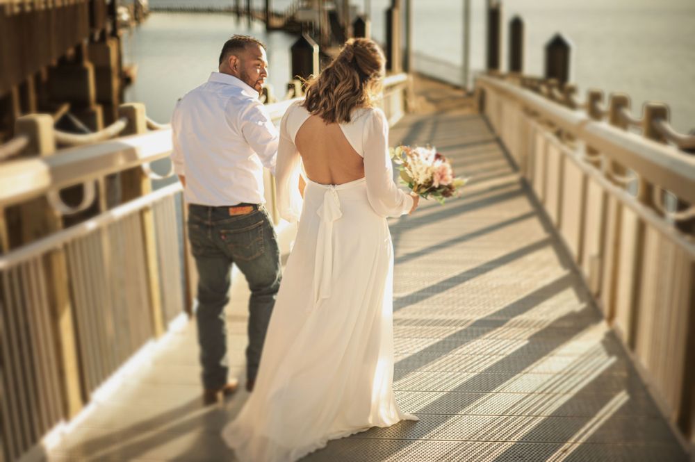 Bride and groom on a dock in portraits in CDA Idaho. Lake CDA. Taken by Jessica Rae Photography.