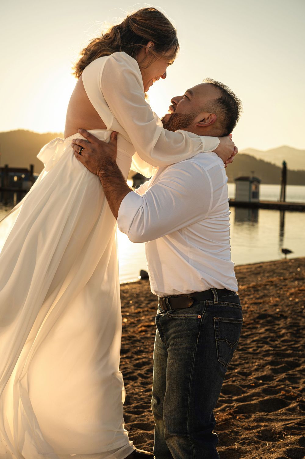 An elopement portrait in CDA Idaho on a beach. Taken by Jessica Rae Photography.