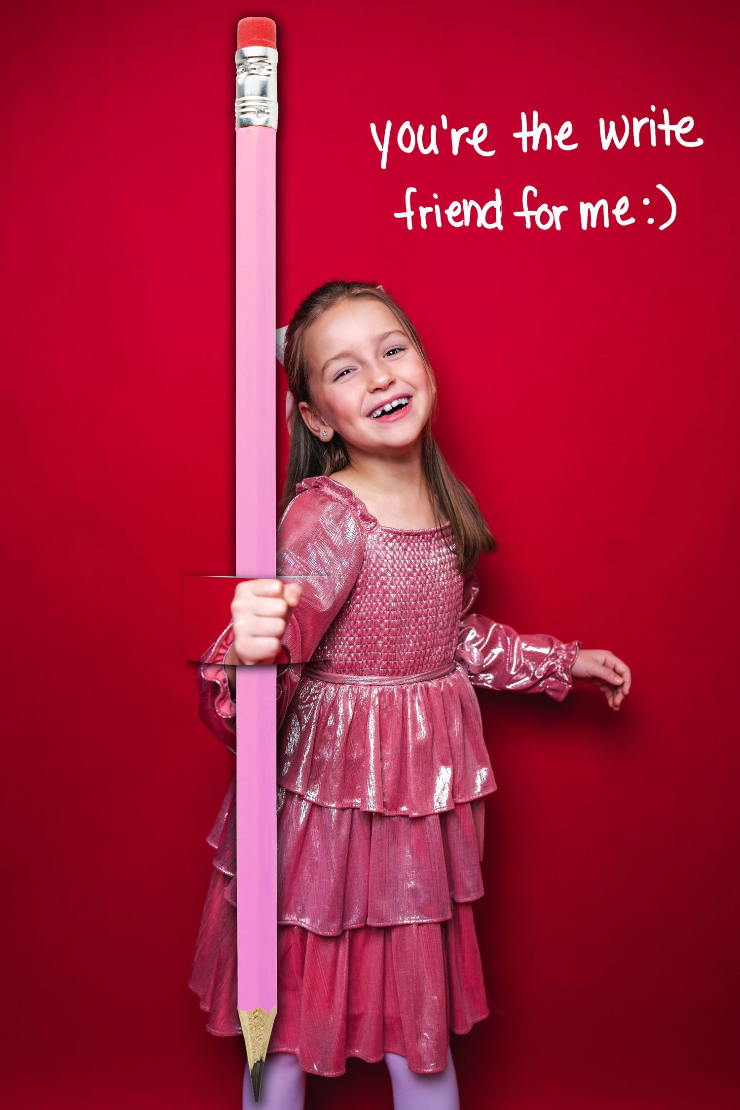 A large decorative pencil prop is held against a bright red background with handwritten text about friendship.