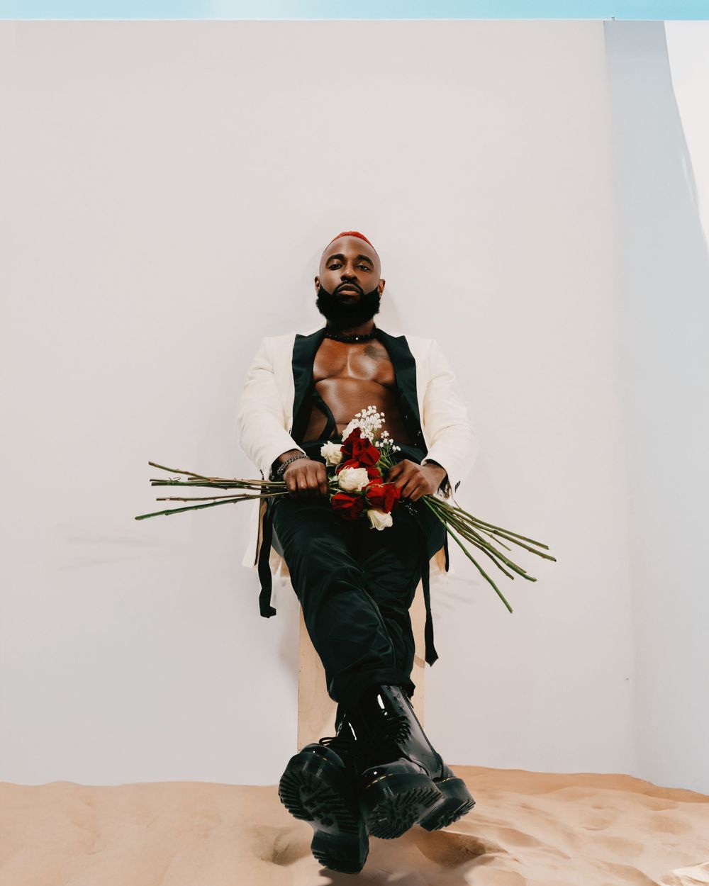 Artistic fashion portrait with roses against minimalist white background.