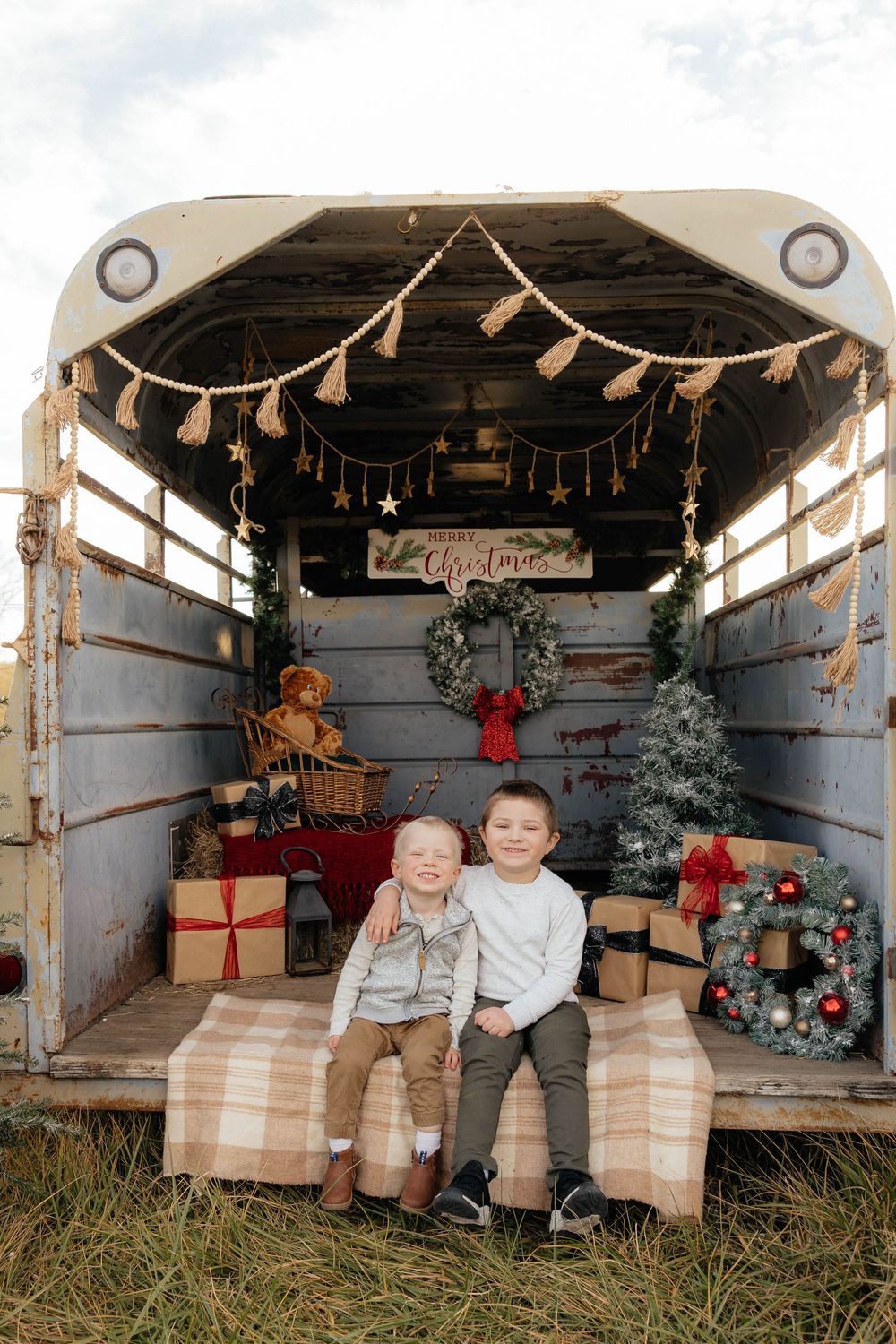 Cozy holiday scene with string lights and decorations in a rustic wooden barn setting.