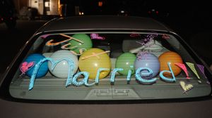 Colorful artistic graffiti text spans across multiple window panels creating a vibrant urban display at night.