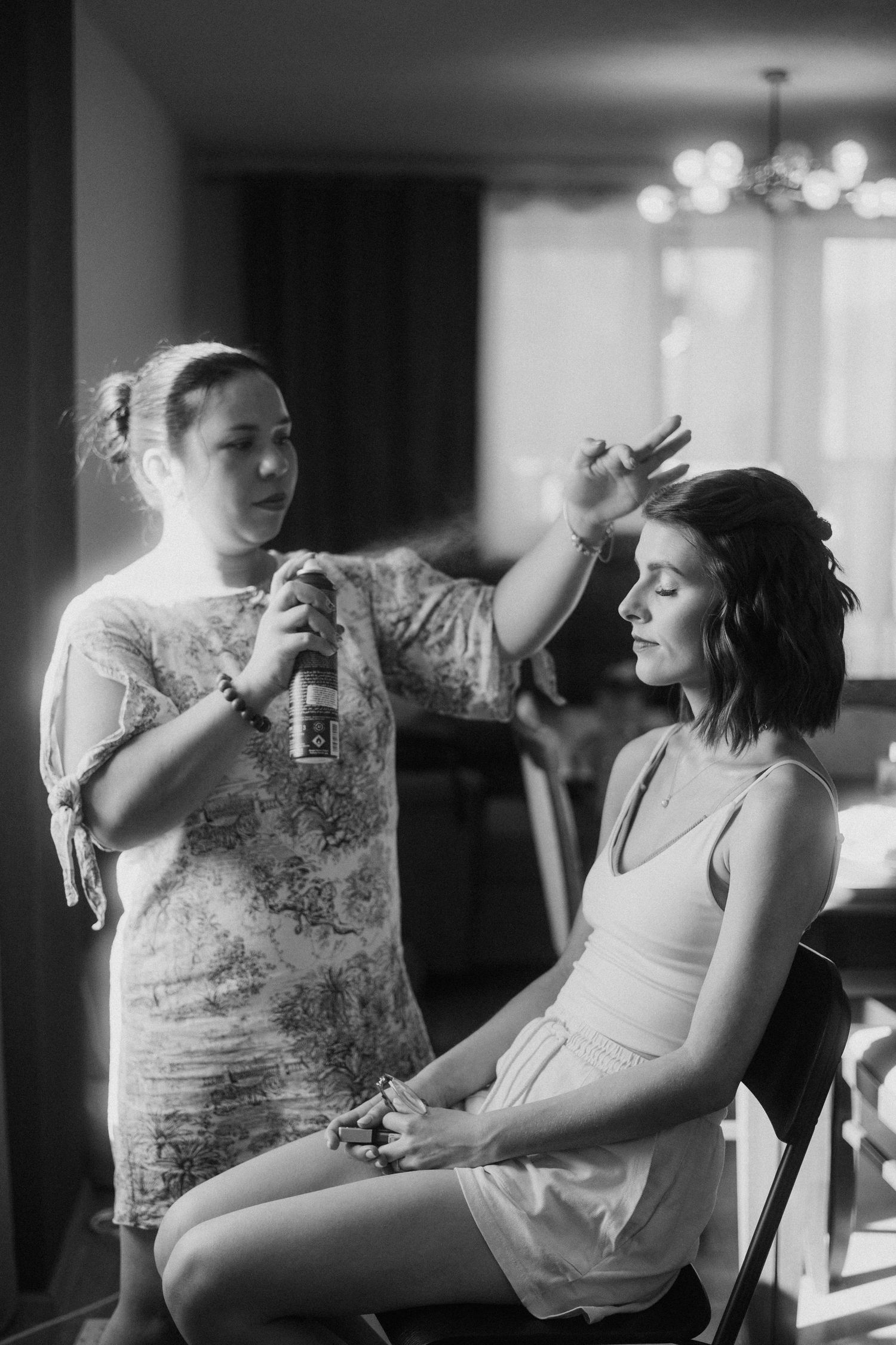Black and white image of wedding day hair styling preparation.