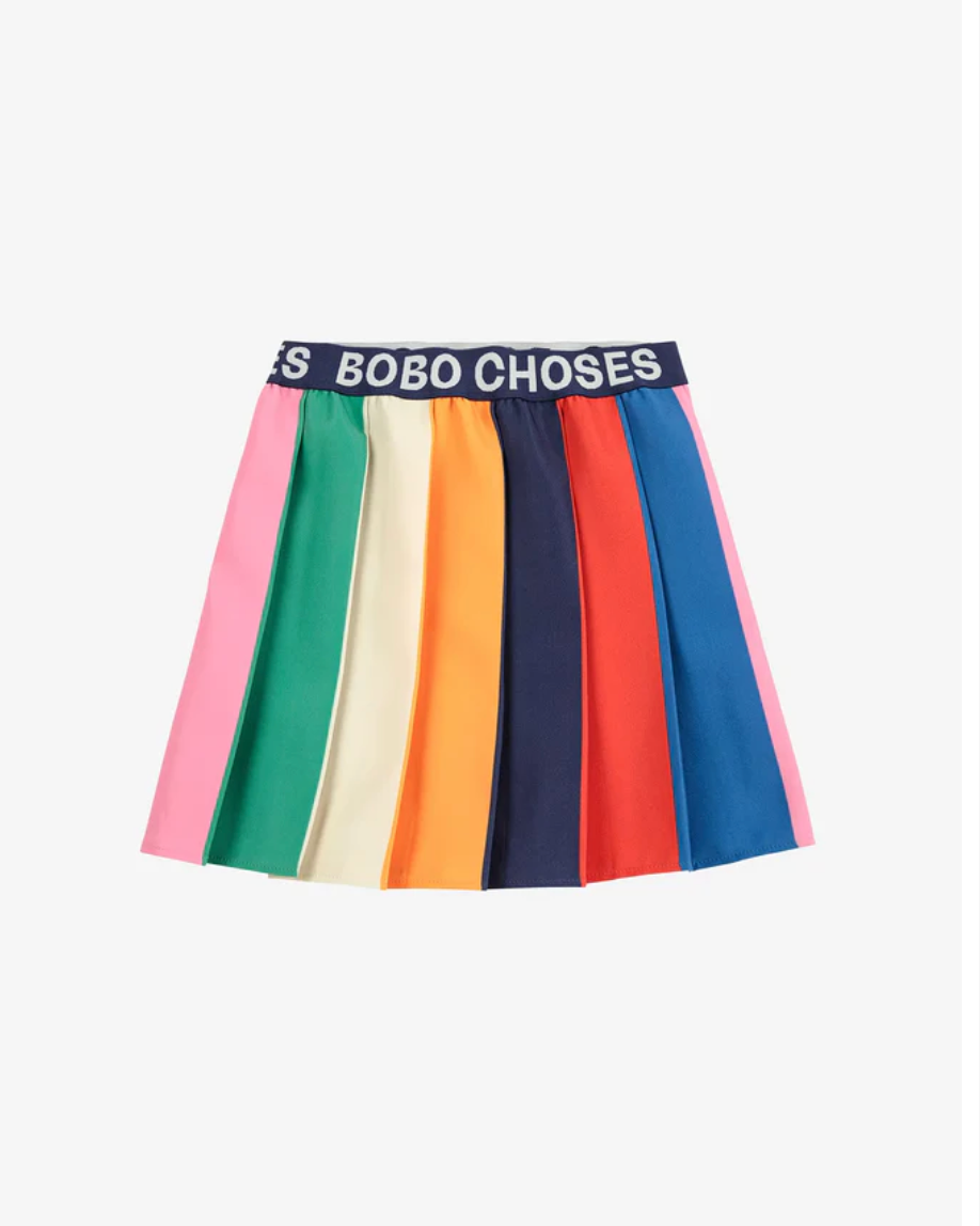 Rainbow striped fabric panel with text 'BOBO CHOSES' in a repeating pattern.