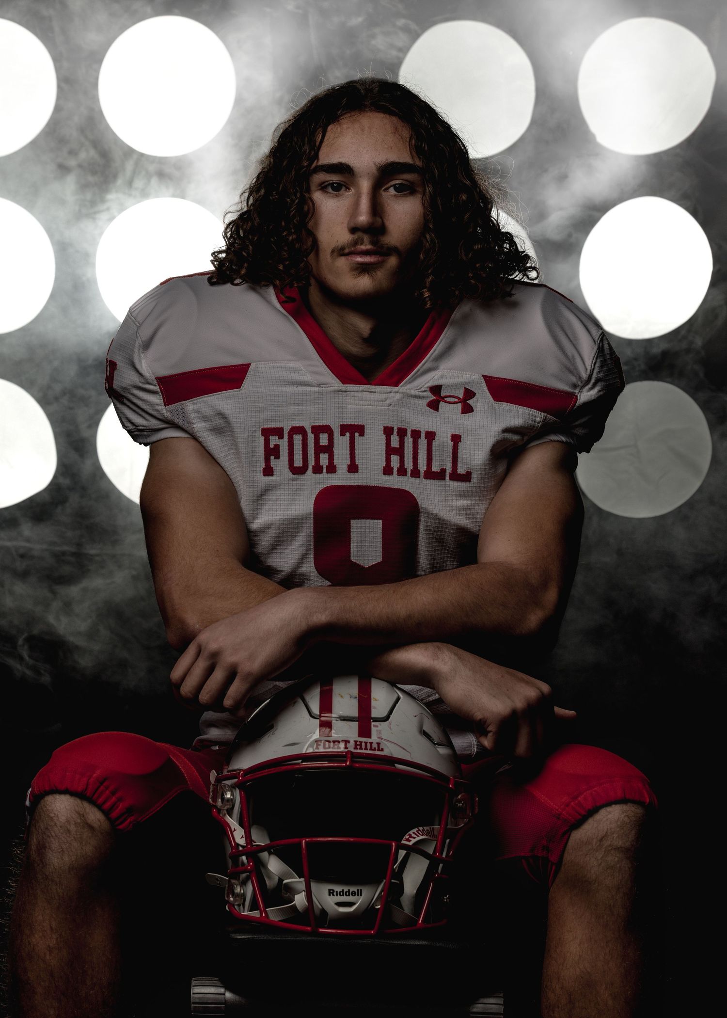 Football player portraits with dramatic lighting and bokeh effects in white and red uniforms.