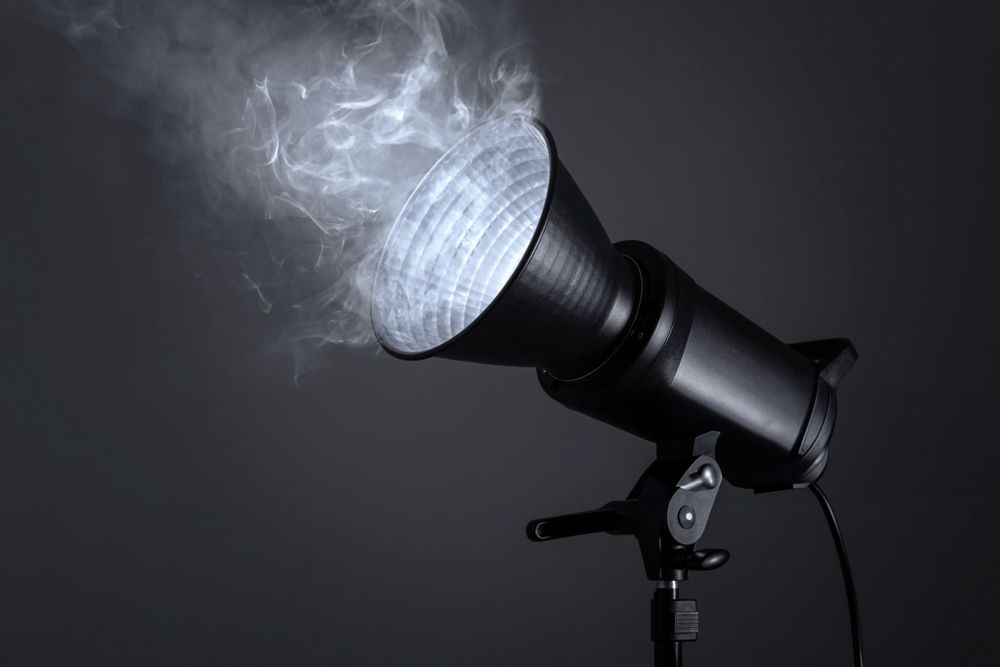 Professional studio light with smoke effect against dark background creating dramatic moody atmosphere.
