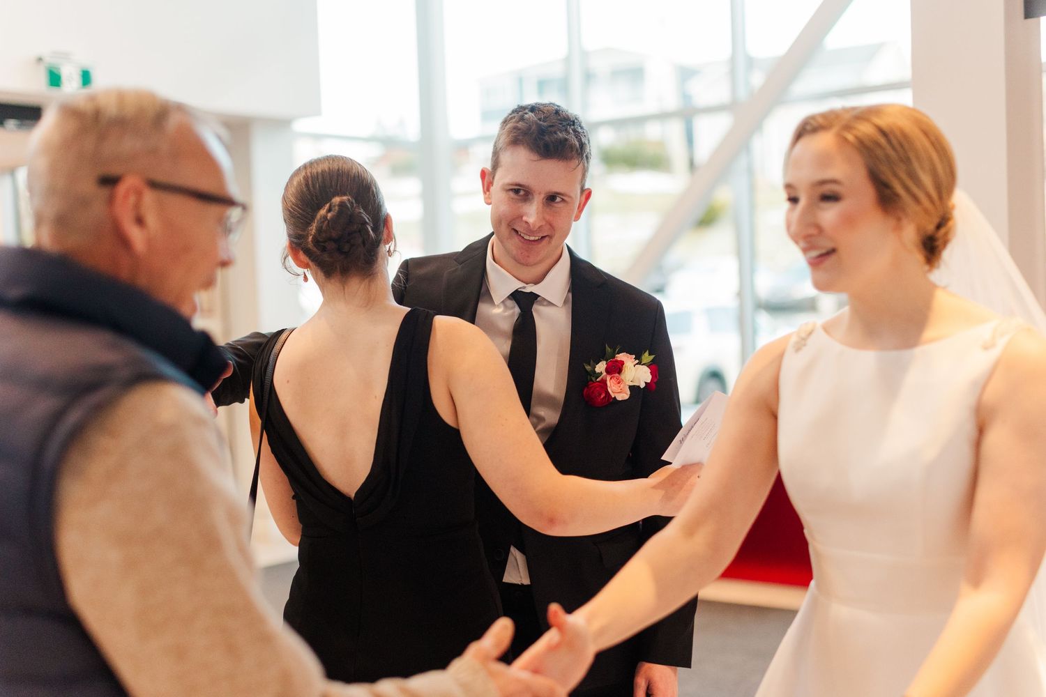 A group of people practicing dance moves together in a bright studio space.