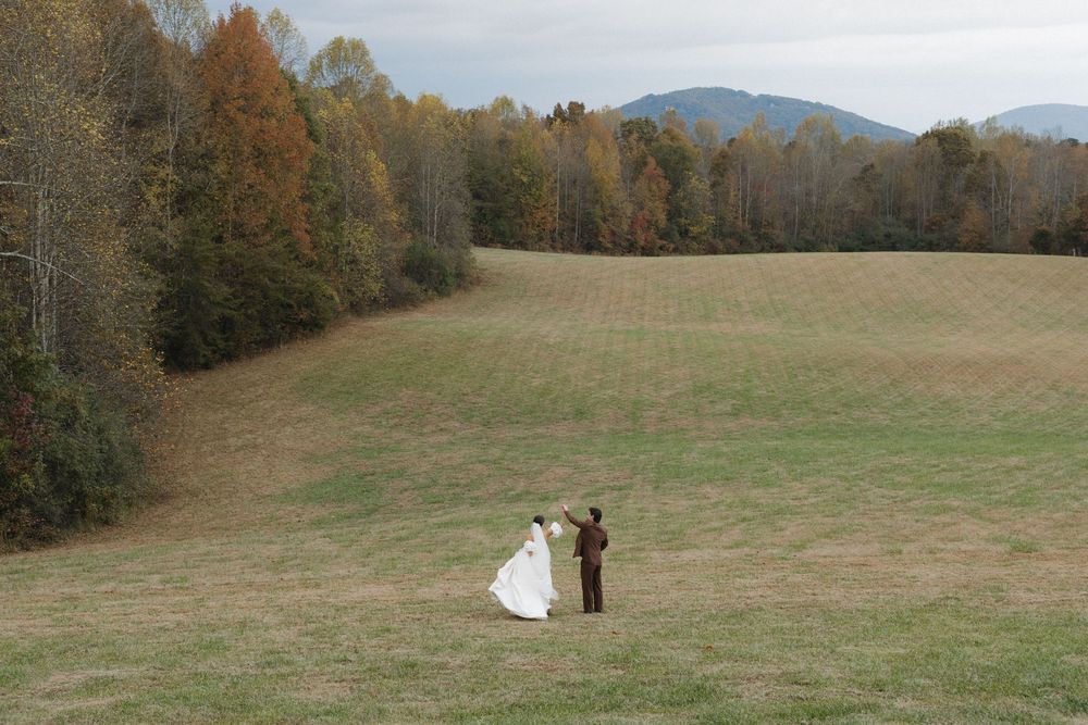 Rolling hills and autumn trees create a scenic landscape view at a rustic outdoor venue.