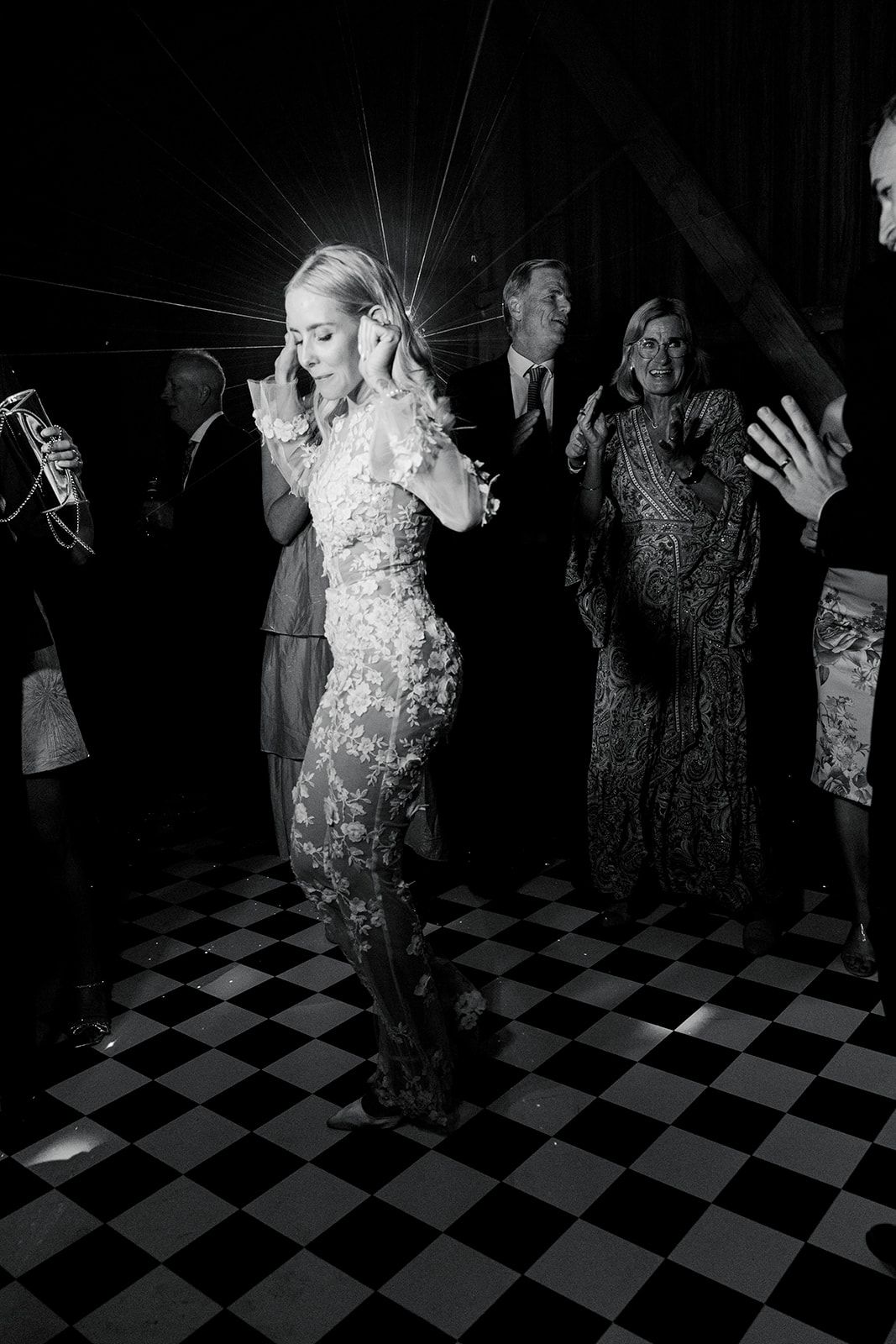 A series of black and white photos showing people dancing on a checkered floor at a party or celebration.