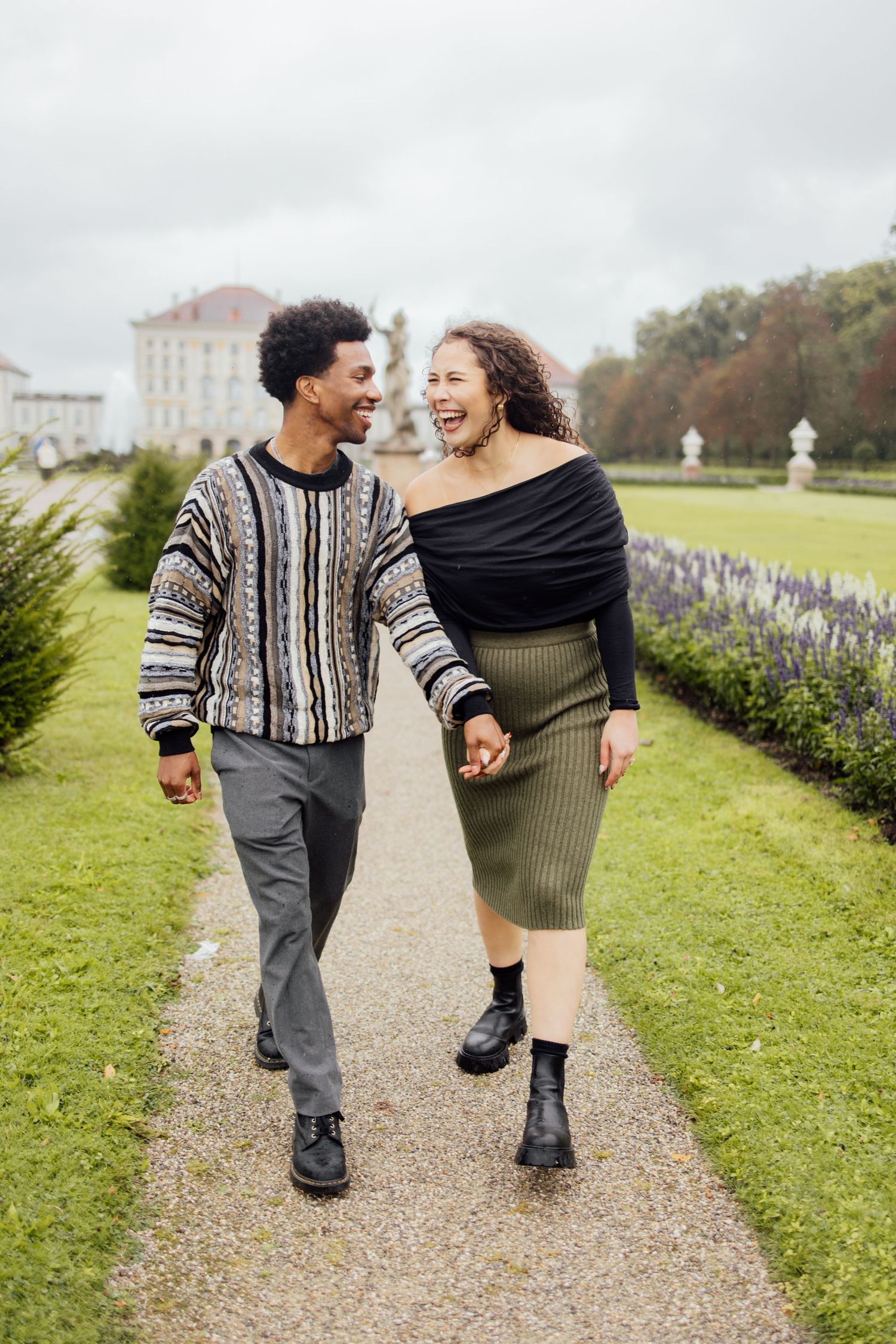 Newly engaged couple smiling holding hands at Nymphenburg palace, Munich Elopement Photographer, Munich Proposal Photographer