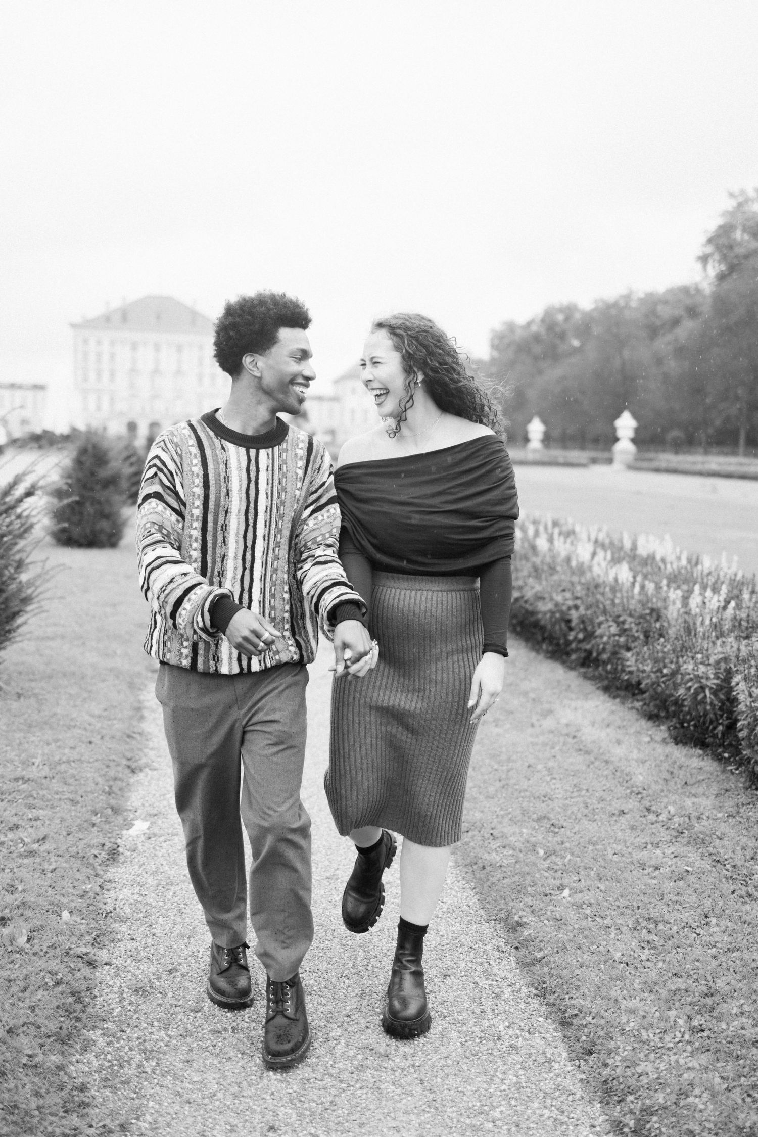 Newly engaged couple smiling holding hands at Nymphenburg palace, Munich Elopement Photographer, Munich Proposal Photographer
