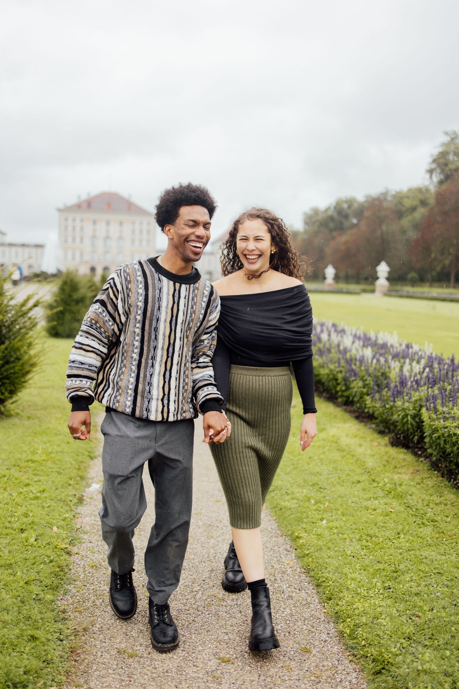 Newly engaged couple smiling holding hands at Nymphenburg palace, Munich Elopement Photographer, Munich Proposal Photographer