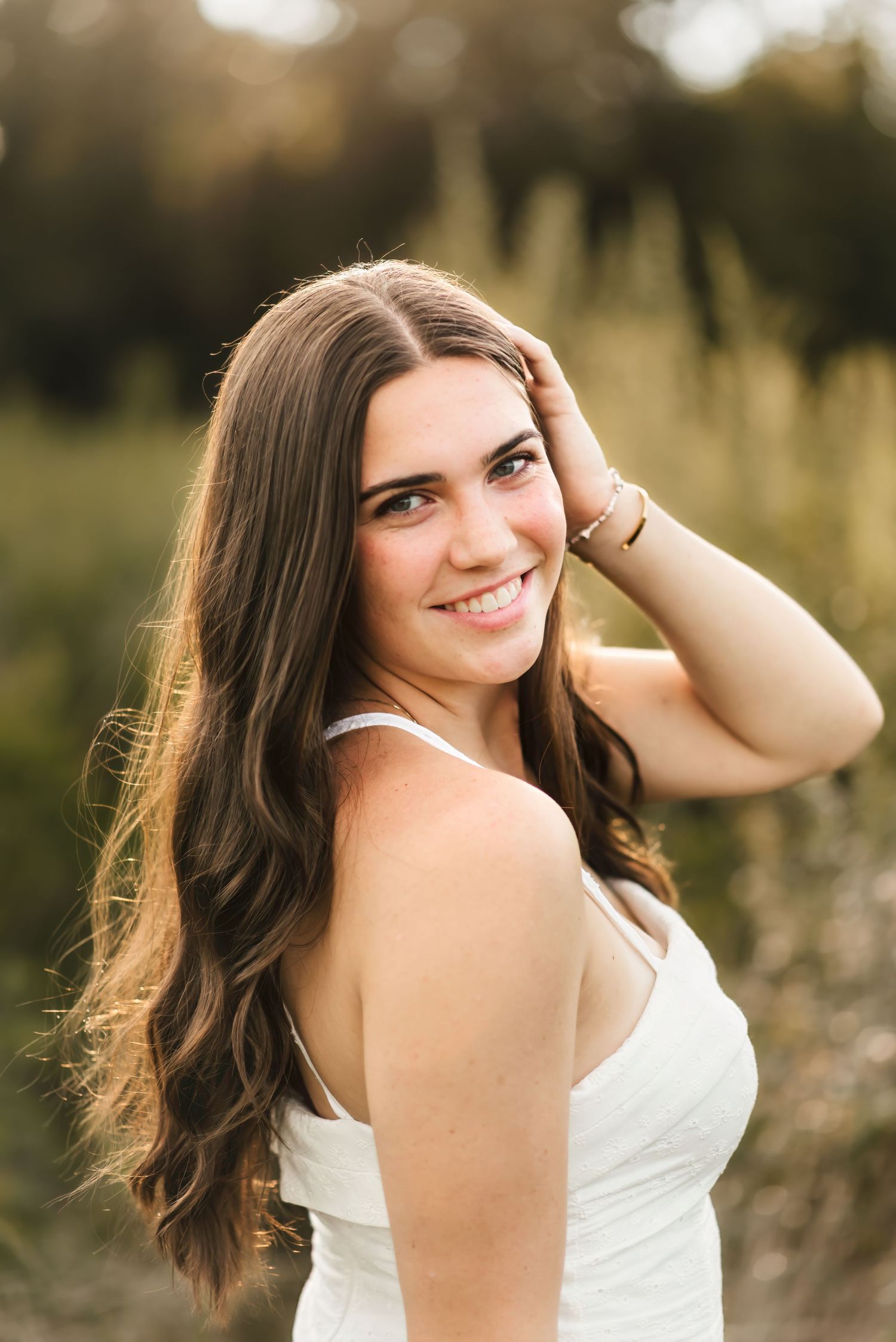 senior girl smiles at camera during her senior photo session in cincinnati