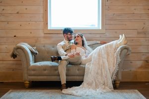 Playful wedding portraits on wooden floor showing couple in relaxed poses.