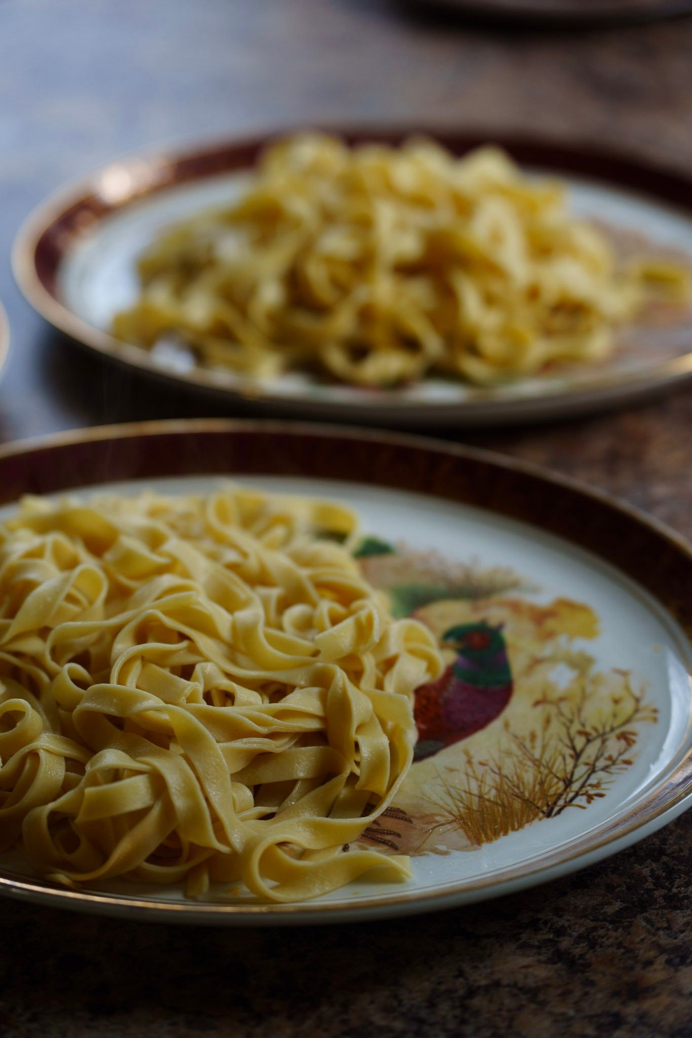 A sequence of photos showing someone sitting at a table with a plate of food in a dimly lit restaurant setting.