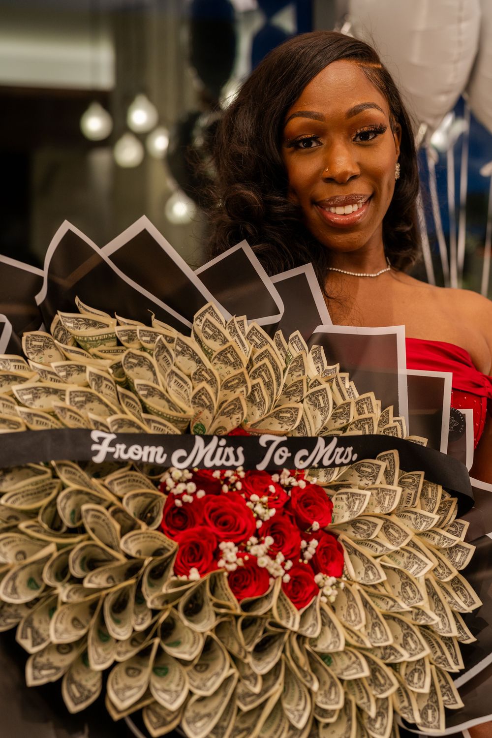 Close-up shots of an ornate money bouquet decorated with red roses and wedding text.