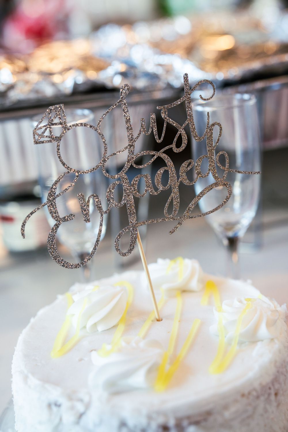 Glittery silver cake toppers decorating white frosted desserts.