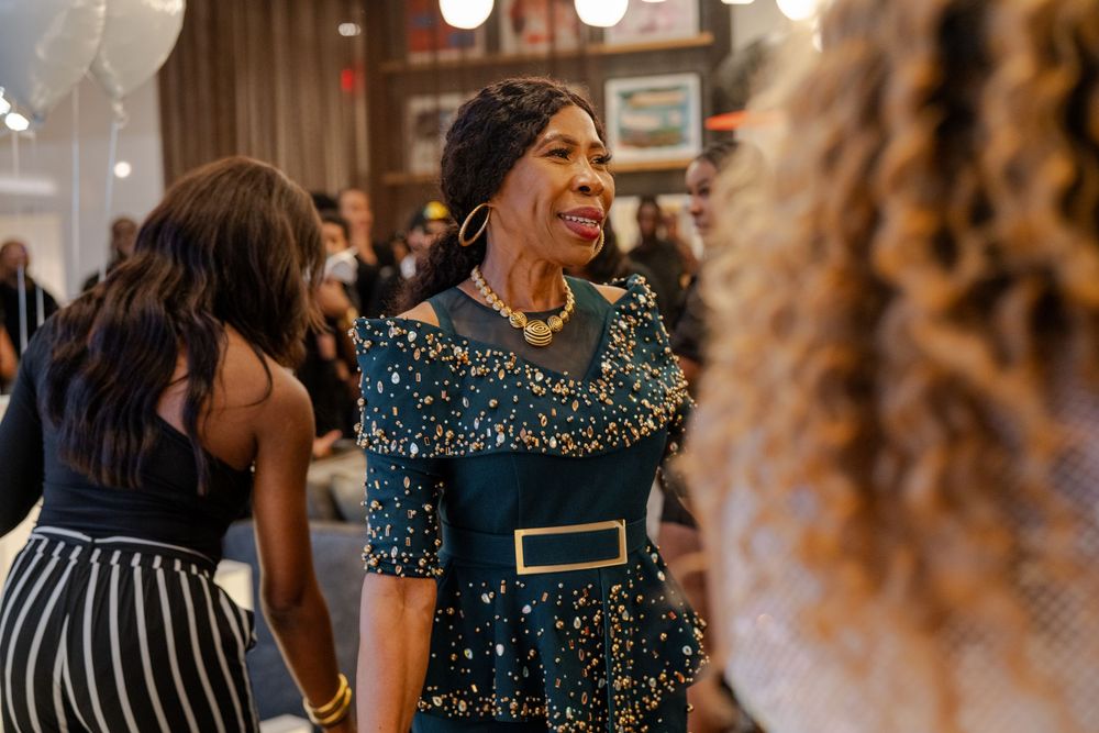Guests mingling at an elegant indoor event with sparkly formal attire.