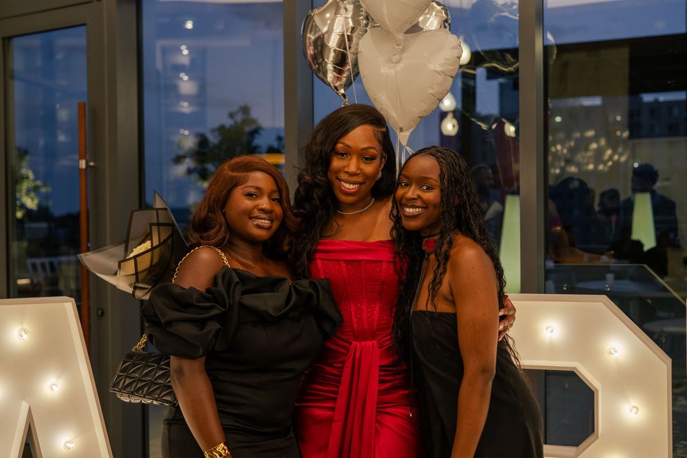 Group celebration moment captured at an evening event with decorative lighting.