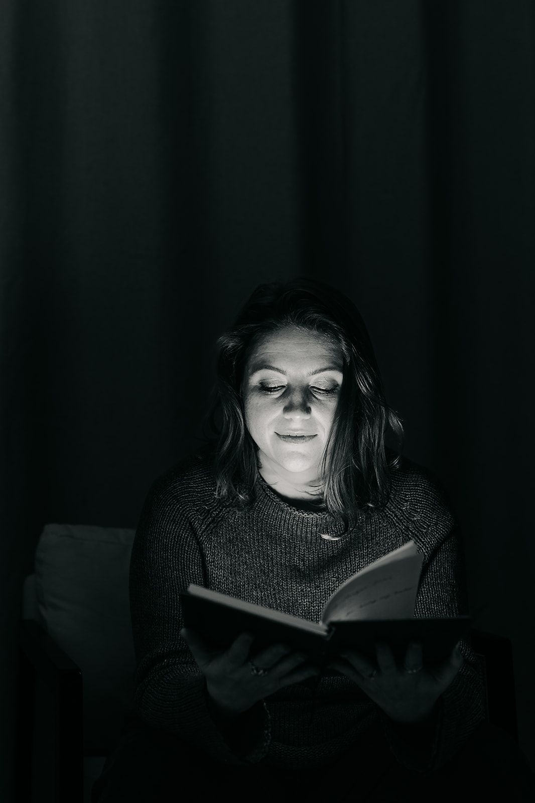 A series of dark moody photos shows someone illuminated by the glow of a digital screen in low light.