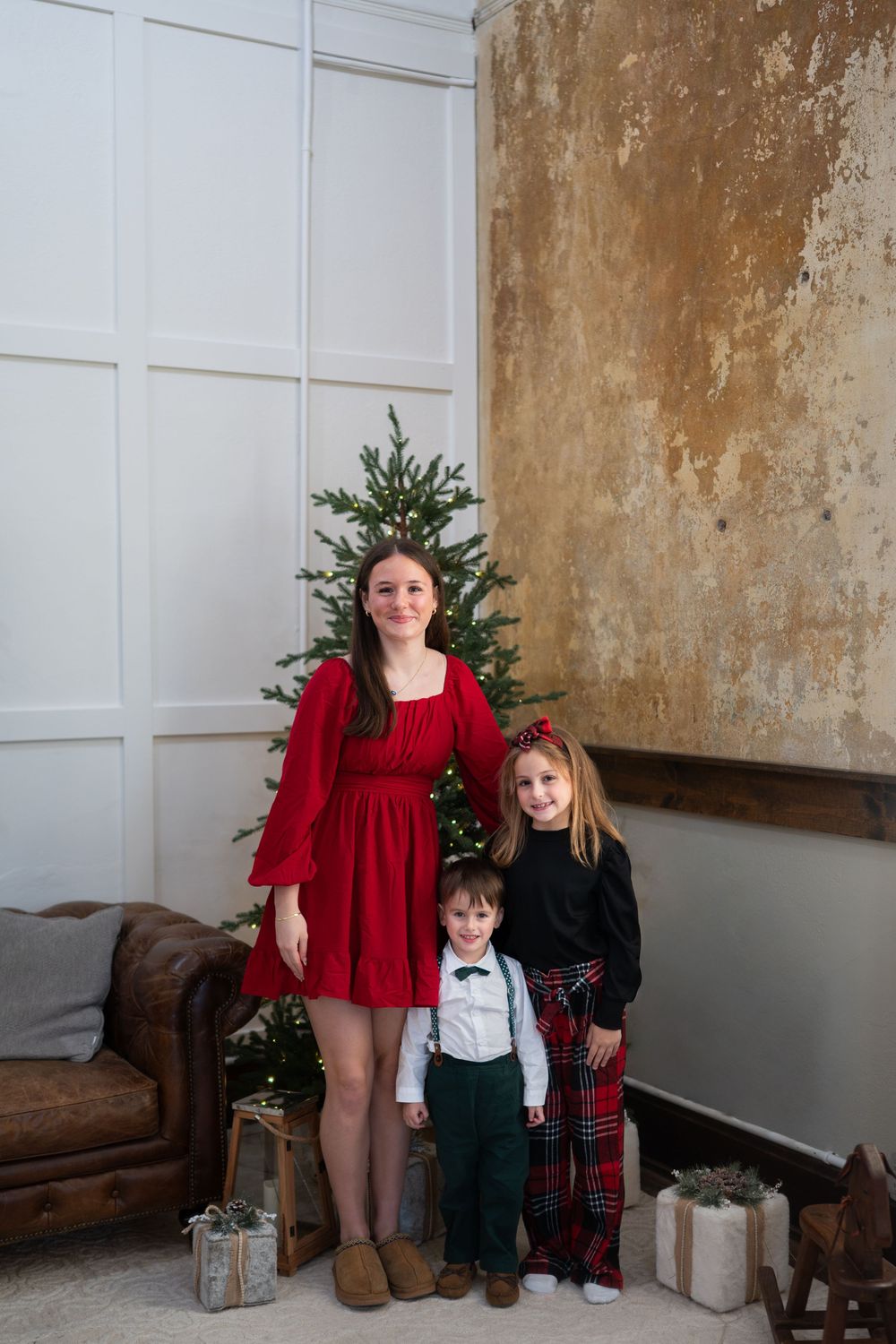 A collage of holiday photos showing people in festive attire with red and green clothing against a rustic wall backdrop.