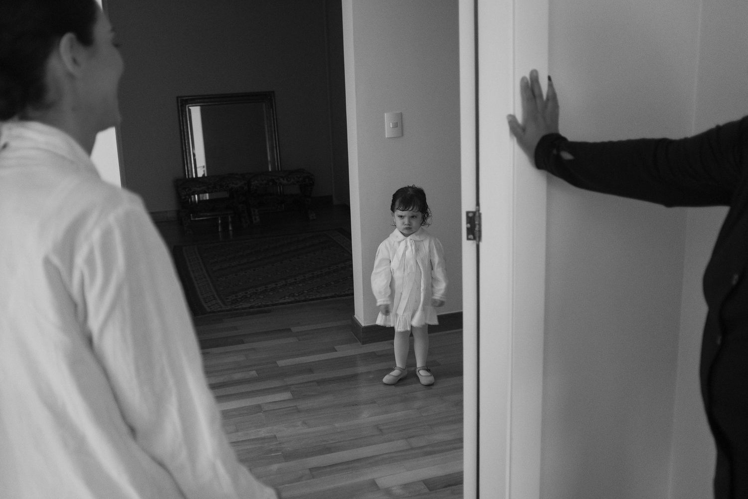 A series of black and white security camera footage frames showing movement through a doorway and hallway.