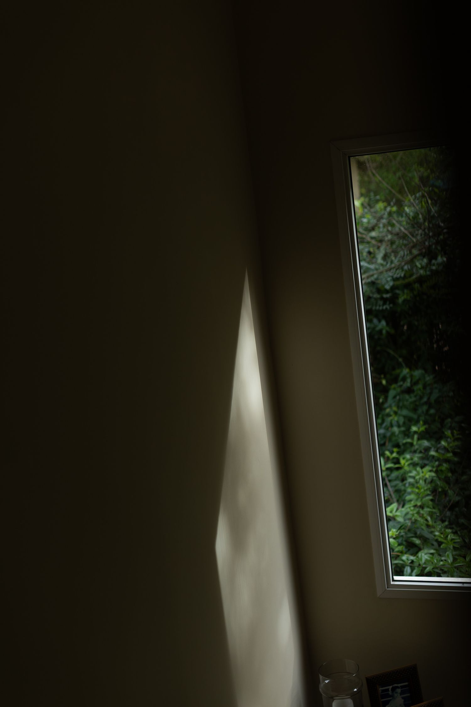 A sequence of images showing sunlight beams moving across a dark wall through a window, creating dramatic shadows.