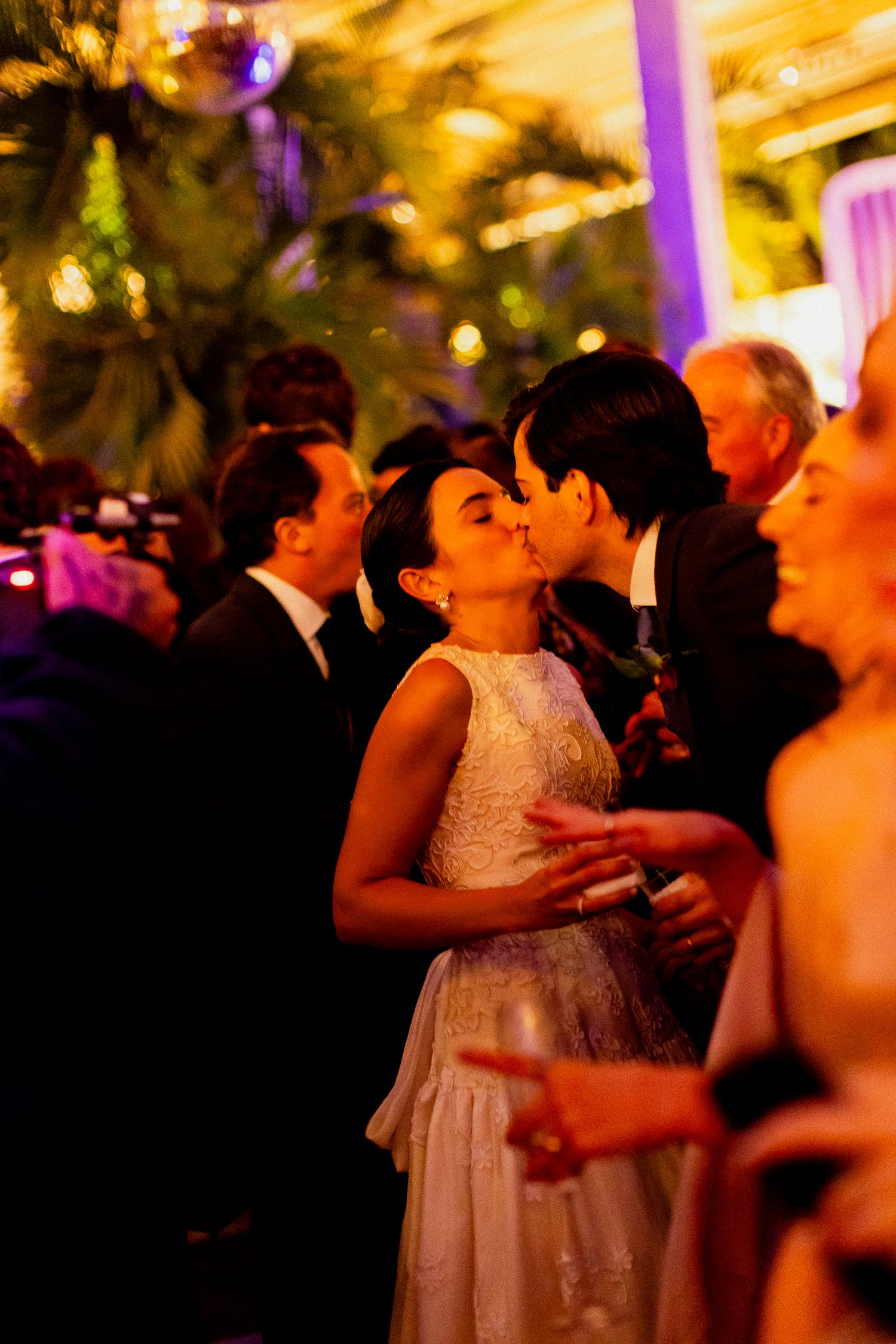 Romantic evening celebration with warm lighting and elegant formal attire as couples dance and mingle.
