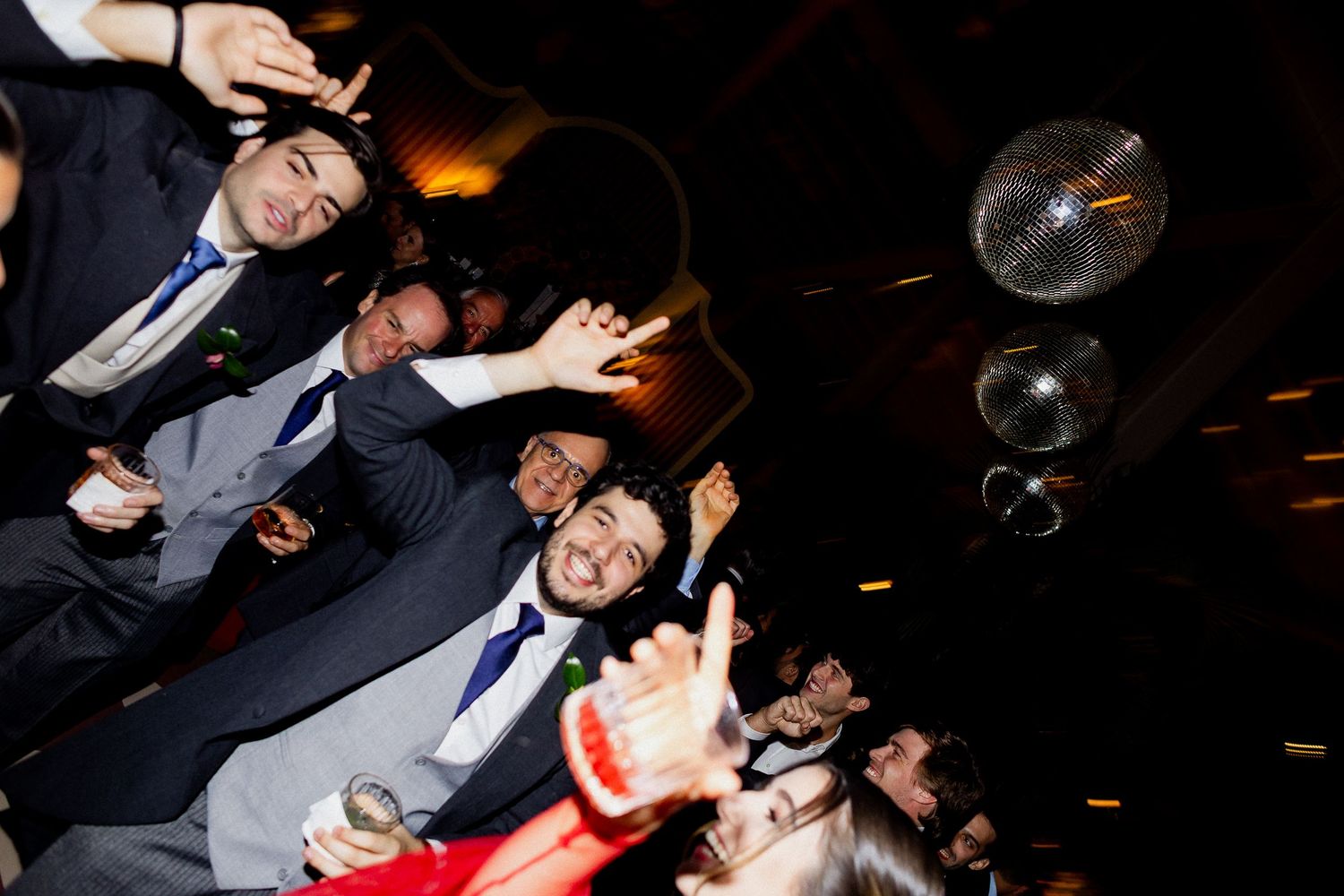 People enjoying themselves at a party with dramatic lighting and dark ambiance.