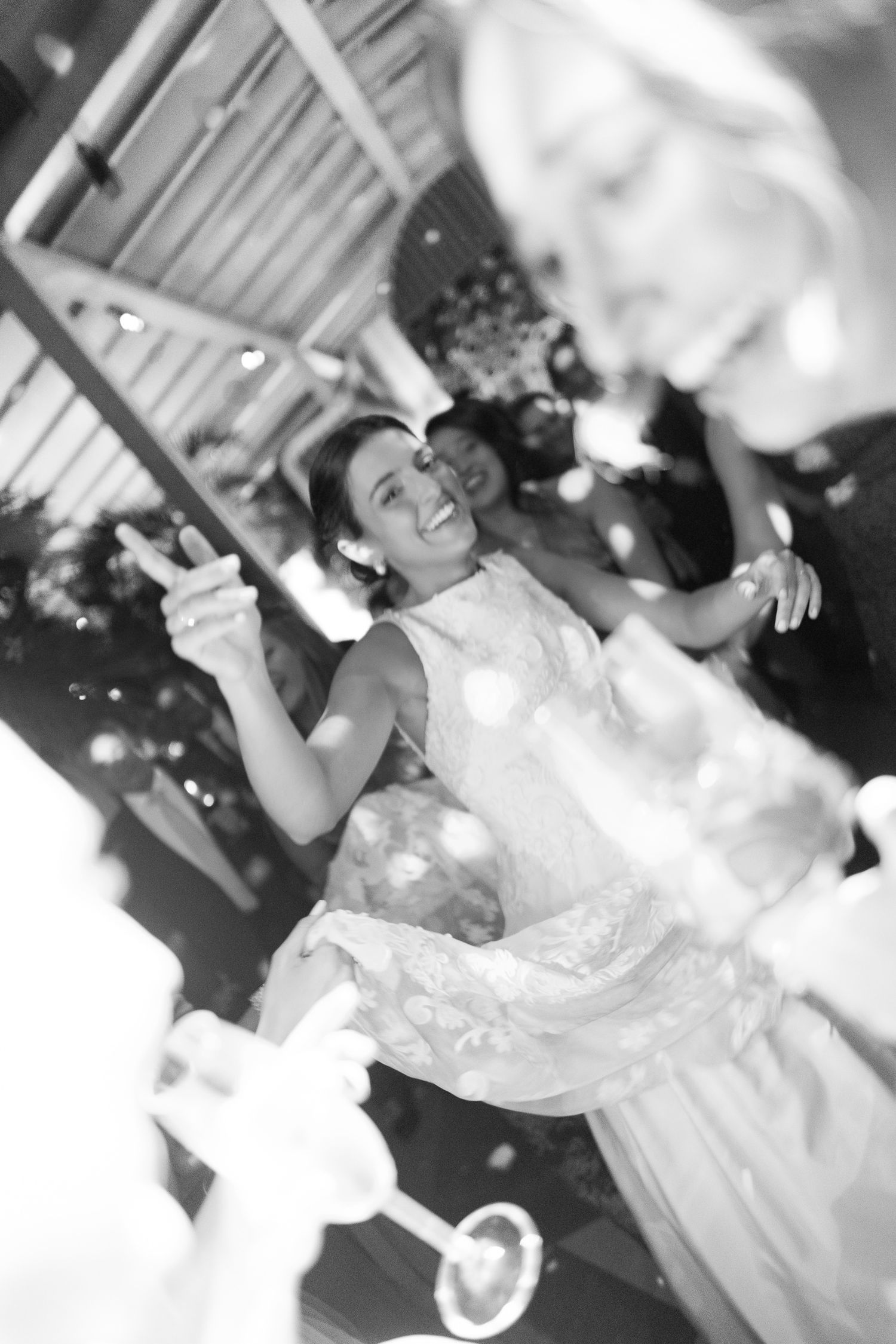 Wedding guests dancing and celebrating joyfully on the dance floor at a reception party.