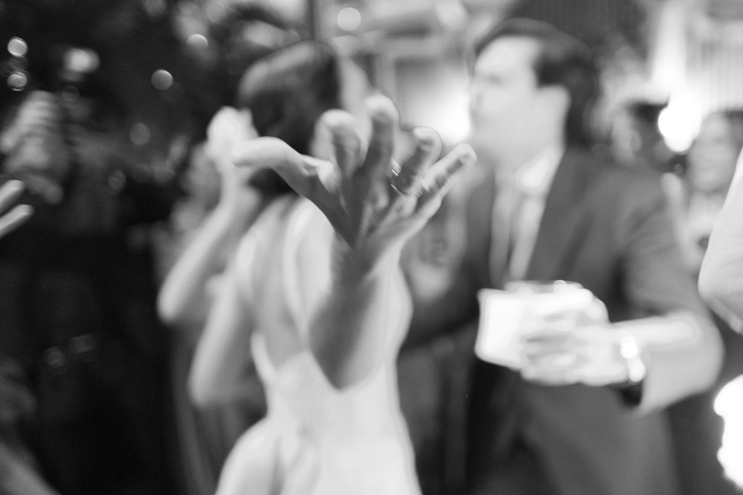 A black and white photo collage shows people dancing and celebrating at what appears to be a wedding reception.