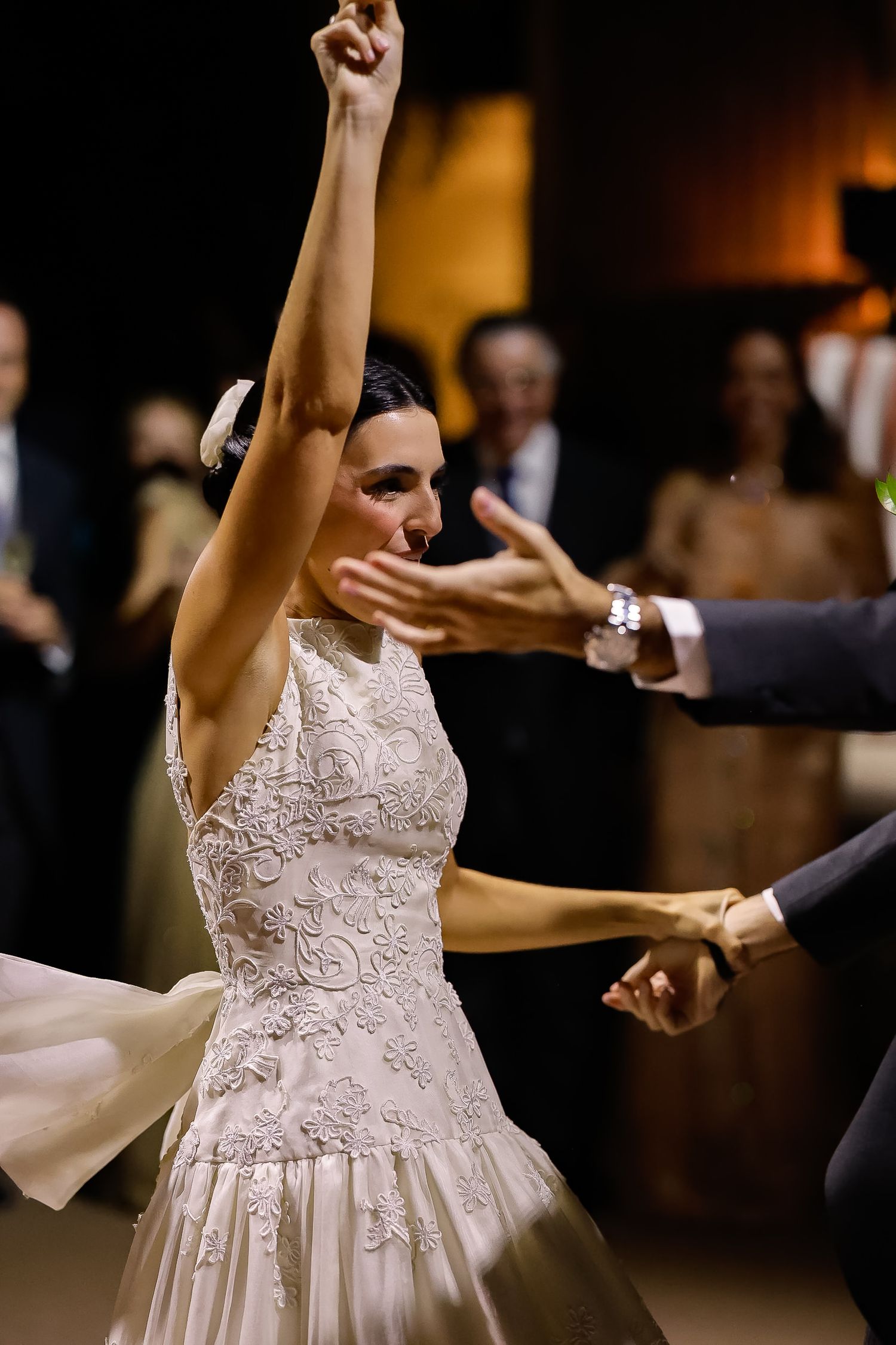 A sequence of photos shows a bride in a white lace dress dancing with raised arms at a wedding reception.