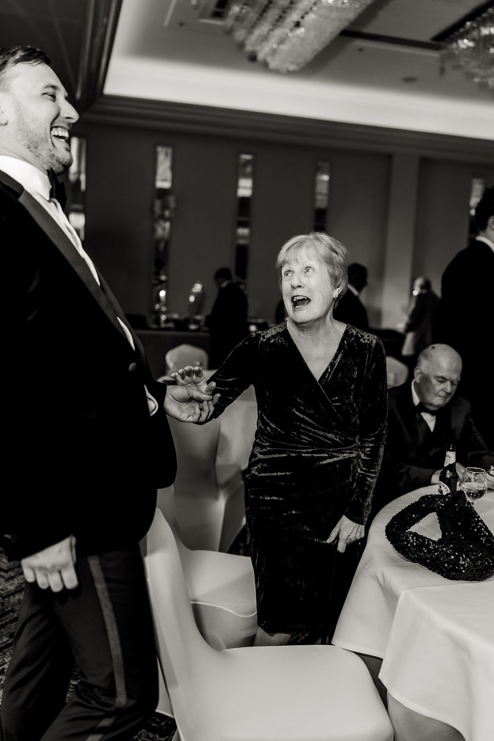 Guests enjoying themselves on a dance floor at an indoor event with elegant lighting.