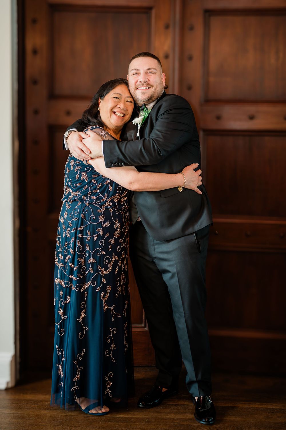 A heartwarming sequence of three dance poses between two people in formal attire against a wooden wall.