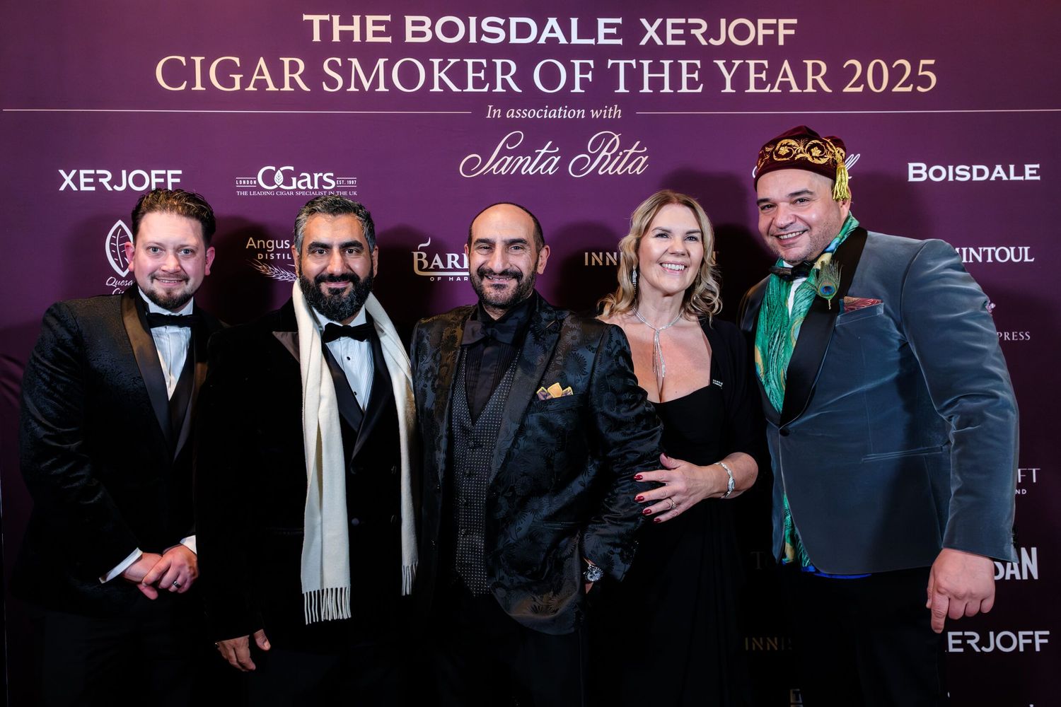 Event attendees gather in front of a branded backdrop at The Boisdale Xerjoff Cigar Smoker awards ceremony.