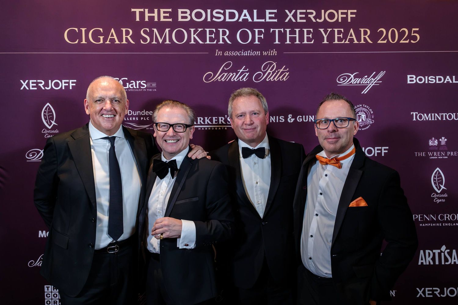 Four people in formal black tie attire pose together at The Boisdale XF1OFF Cigar Smoker of the Year 2025 event.