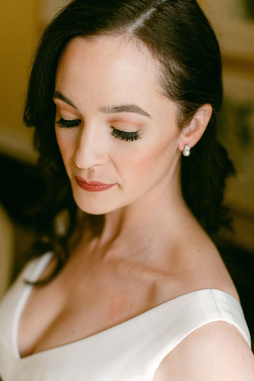 Close-up portrait shots showing elegant bridal makeup and hair styling with red lipstick and dark eye makeup.