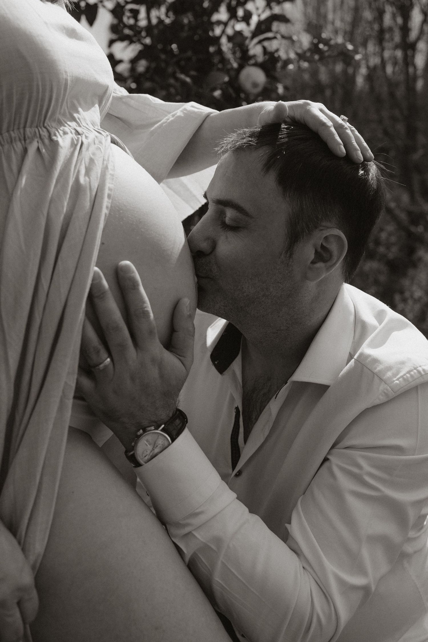 Monochrome photograph capturing emotional connection during maternity session.