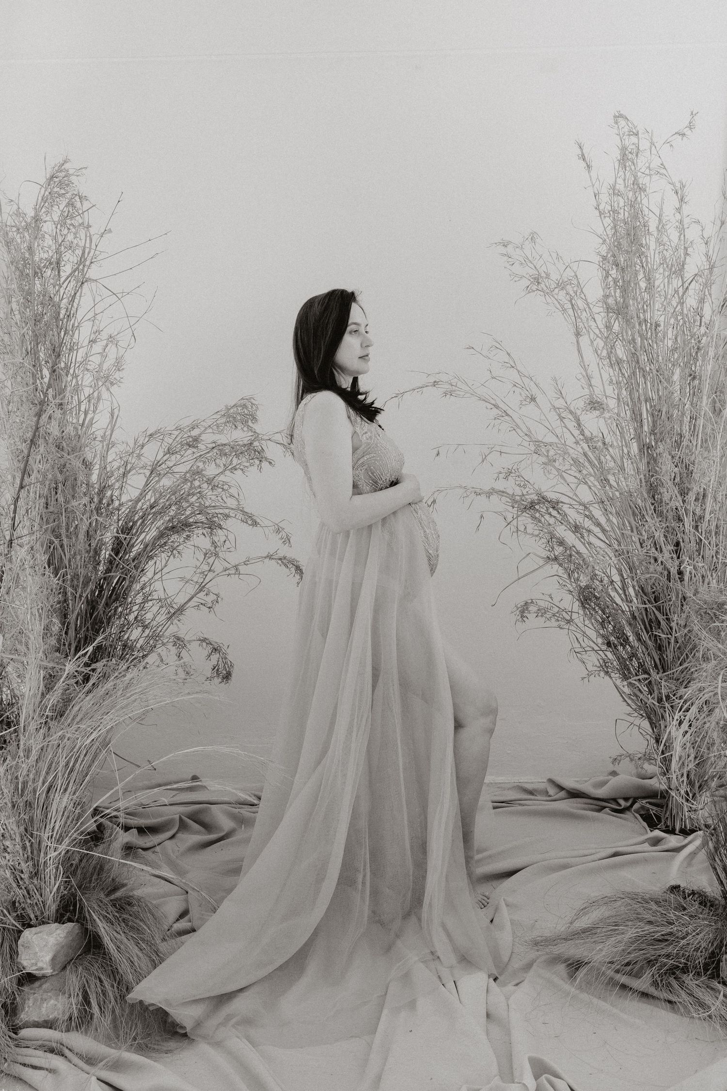Ethereal black and white photo series featuring a flowing white dress against bare branches.
