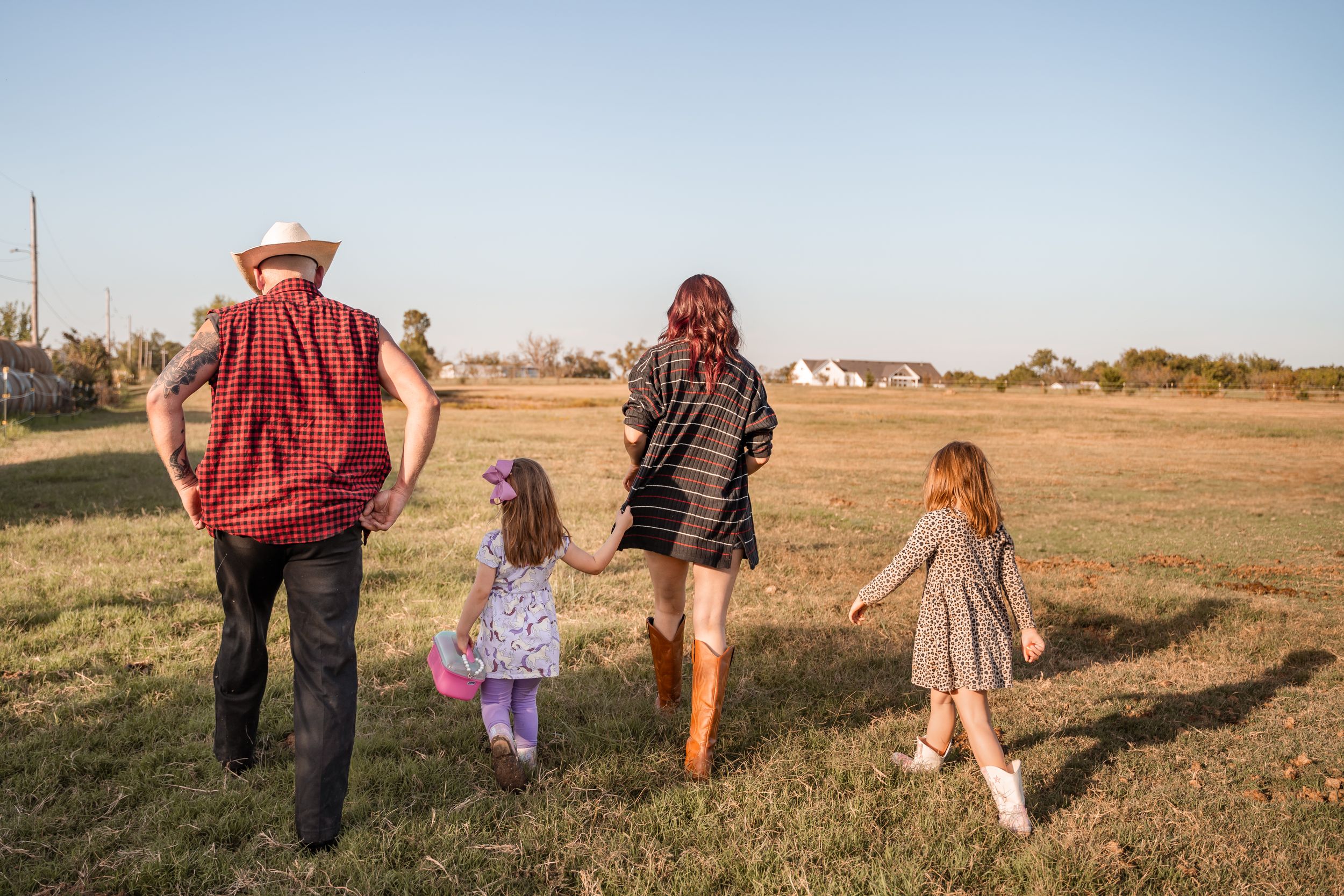 Tulsa photographer captures a family all together walking through their pasture during documentary session