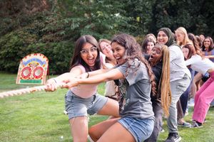 People engaged in fun outdoor group activities and games on a sunny field.